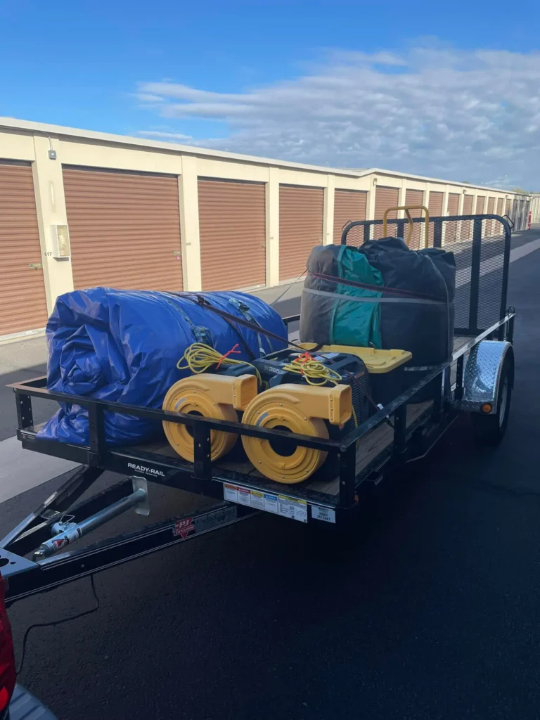 The chaos bouncers trailer is loaded with inflatable rentals and accessories for a birthday party rental